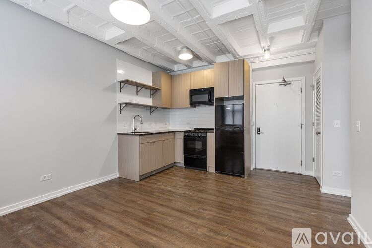 A kitchen with wooden floors and white walls.