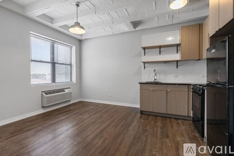 A kitchen area with wooden floors and a black oven.