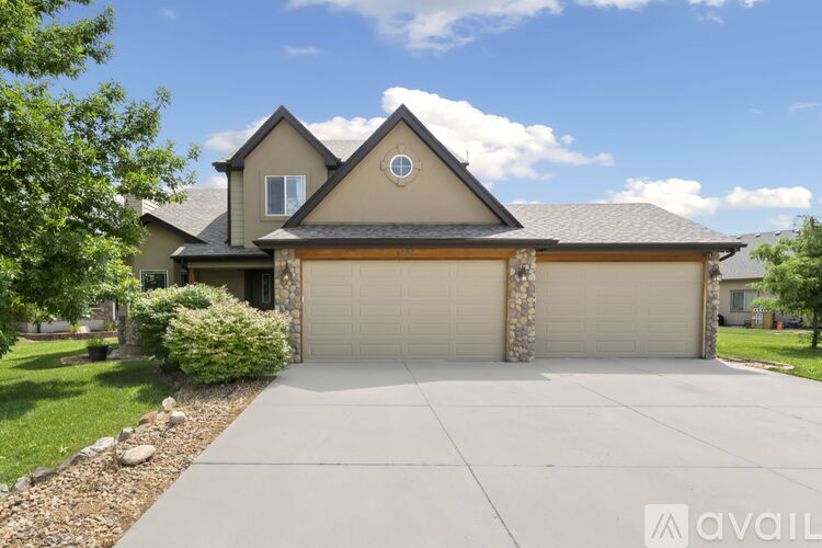 A house with a stone pillar and a garage door.