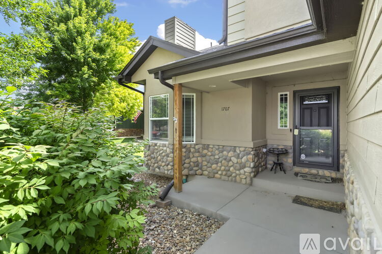 A house with a stone wall and a glass door.