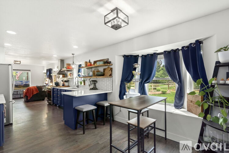 A kitchen with blue cabinets and a white countertop.