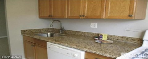 A kitchen with a sink and a dishwasher.