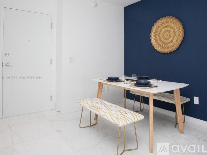 A dining table with two chairs and a woven placemat on a white floor.