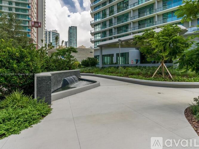 A modern building with a water feature in front.