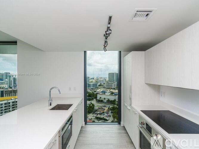 A modern kitchen with a view of the city.