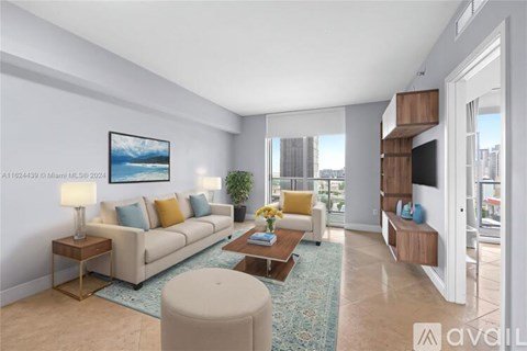 A living room with a couch, a coffee table, and a painting on the wall.