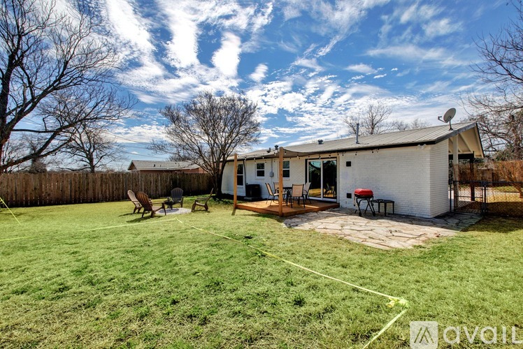 A house with a white exterior and a covered patio area.