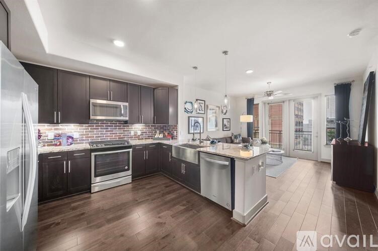 A modern kitchen with dark wood cabinets and stainless steel appliances.