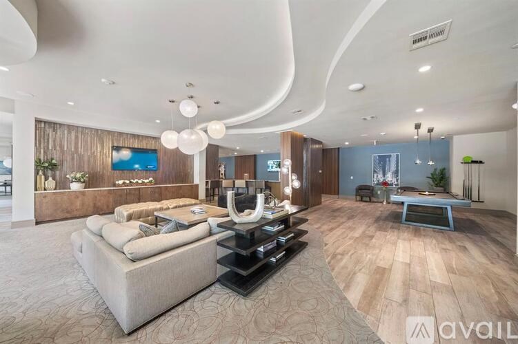 A modern living room with a large couch and a coffee table.