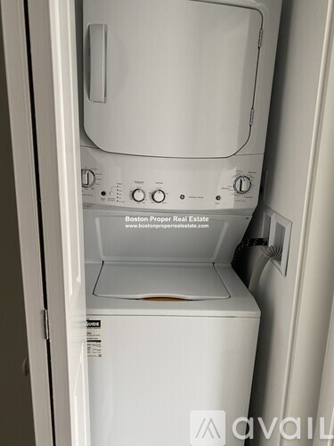 A white washing machine with the door open.