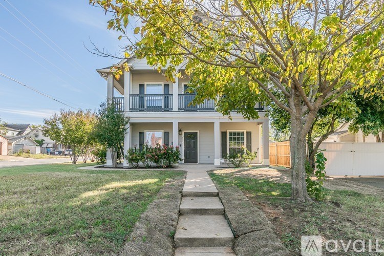A house with a tree in front of it.