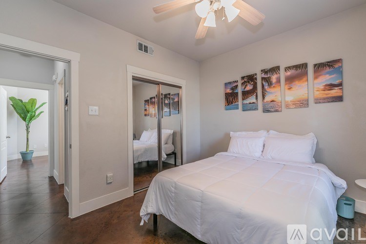 A living room with a grey couch, a wooden coffee table, and a plant.
