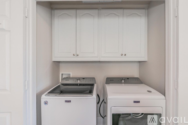 A small laundry room with a washer and dryer.