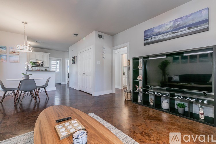 A modern living room with a wooden coffee table in the foreground.