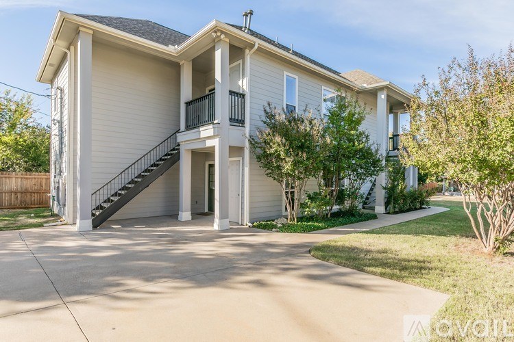 A two-story house with a balcony on the second floor.