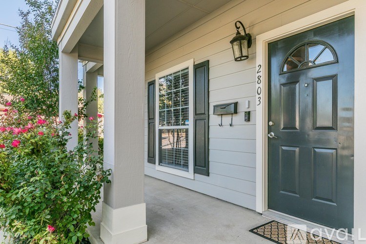 A house numbered 2803 is shown with a grey door and a mailbox.