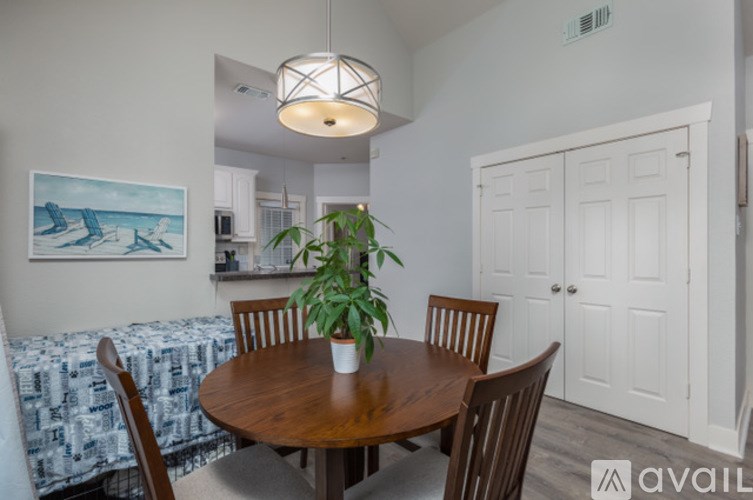 A dining room with a wooden table and chairs.