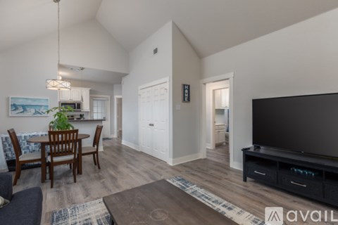 A living room with a television and a dining table.