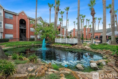 A fountain in the middle of a garden surrounded by rocks and plants.