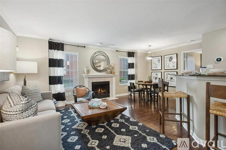 A living room with a fireplace and a dining table.