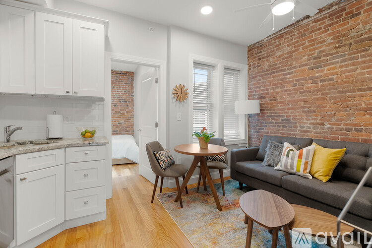 A living room with a grey couch and a wooden table.