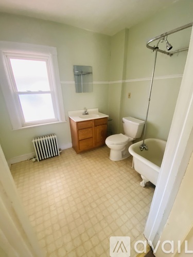 A bathroom with a toilet, sink, and bathtub.