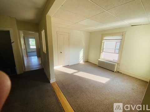 A room with a window and a radiator on the wall.