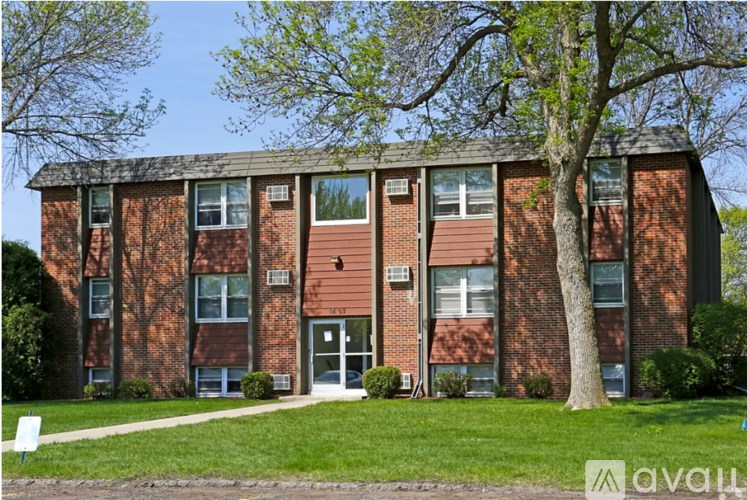 A brick building with a tree in front of it.
