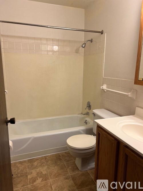 A bathroom with a toilet, sink, and bathtub.