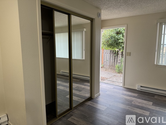 A room with a sliding glass door leading to a backyard.