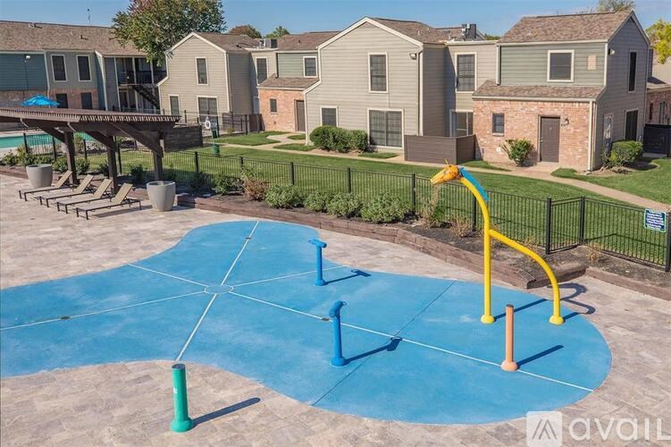 A playground with a blue surface and a yellow structure.
