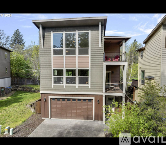 A two-story house with a garage is available for sale.