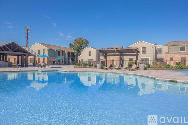 A pool in front of a row of houses with the word "available" on the bottom right.