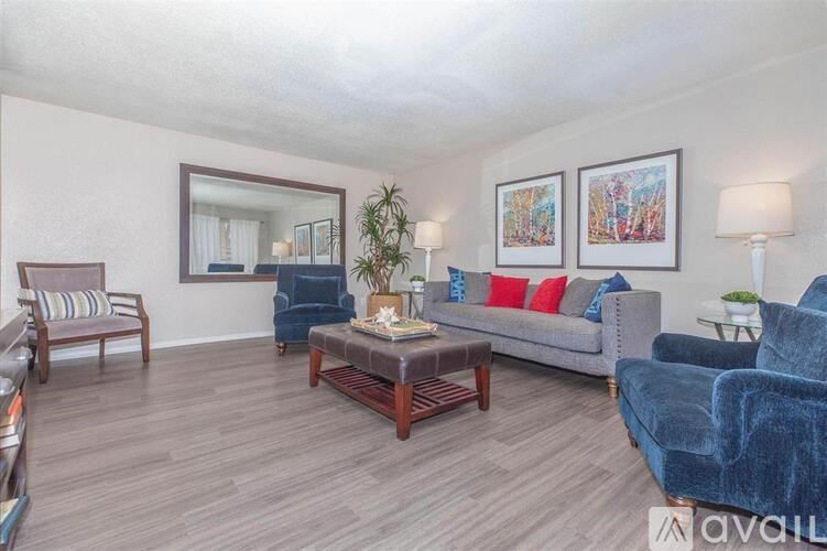 A living room with a blue couch and a coffee table.