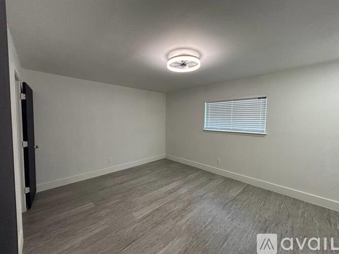 A room with a window and a ceiling fan.