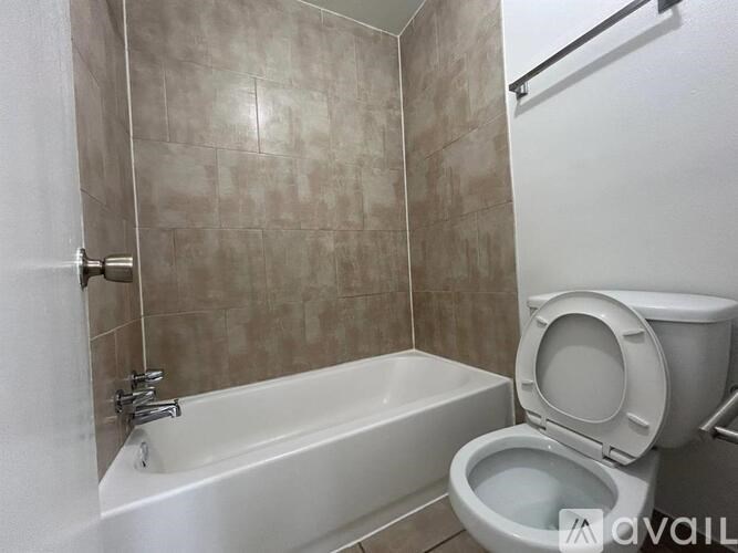 A bathroom with a toilet and a bathtub.