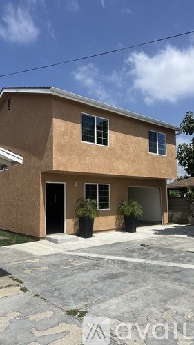 A house with a brown exterior and a black door is shown.
