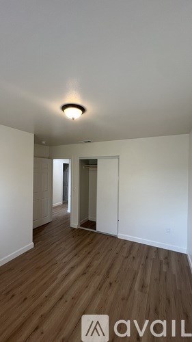 A room with wooden floors and white walls.