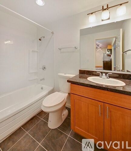 A bathroom with a toilet, sink, and bathtub.