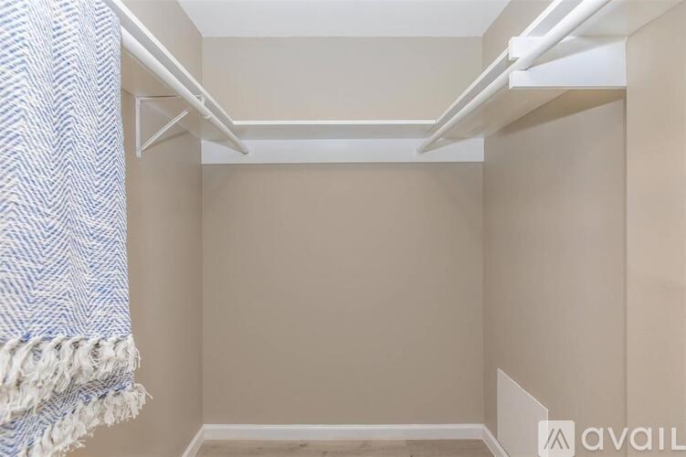 A small, empty room with a single bed on the left side.