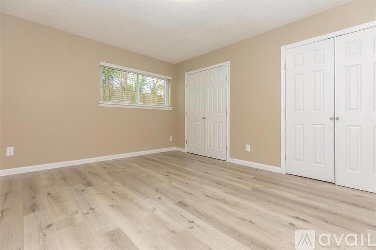 A room with wooden flooring and white doors.