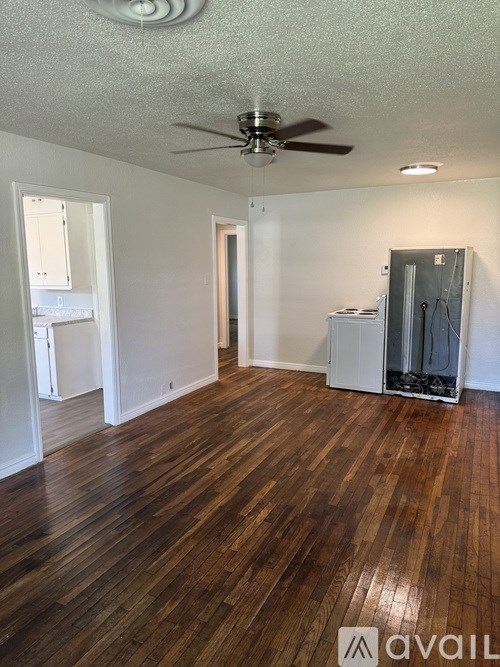 A room with wooden floors and a ceiling fan.