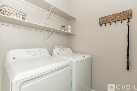 A white washing machine and dryer in a small laundry room.