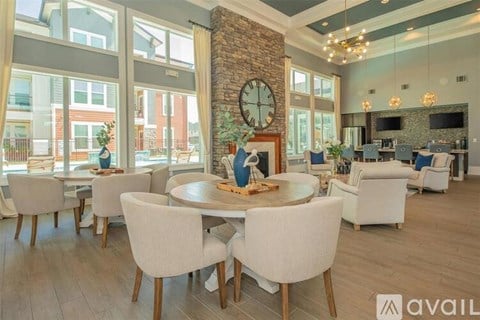 A modern dining room with a large table and chairs.