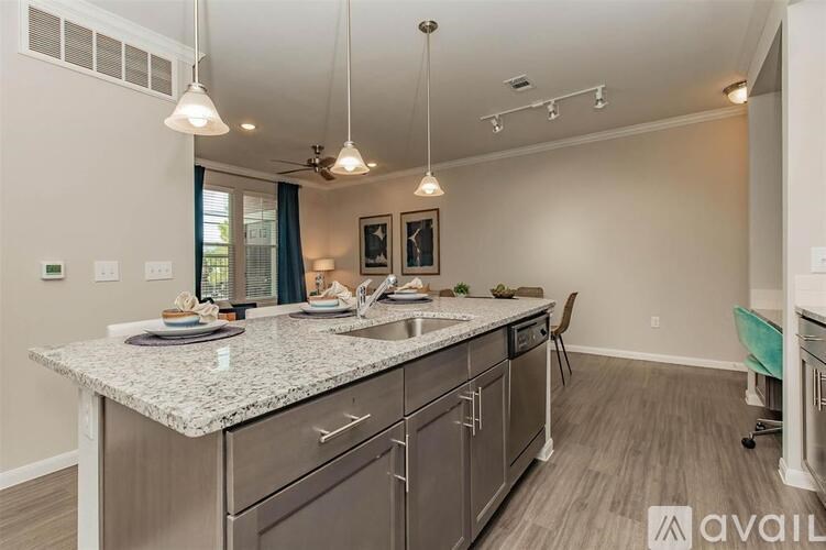 A kitchen with granite countertops and a ceiling fan.