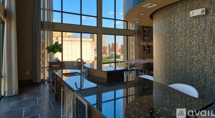 A modern kitchen with a large window overlooking the city.