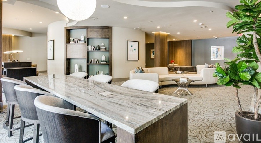A modern dining room with a long wooden table and chairs.