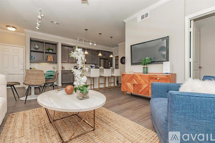 A living room with a white coffee table and a blue couch.