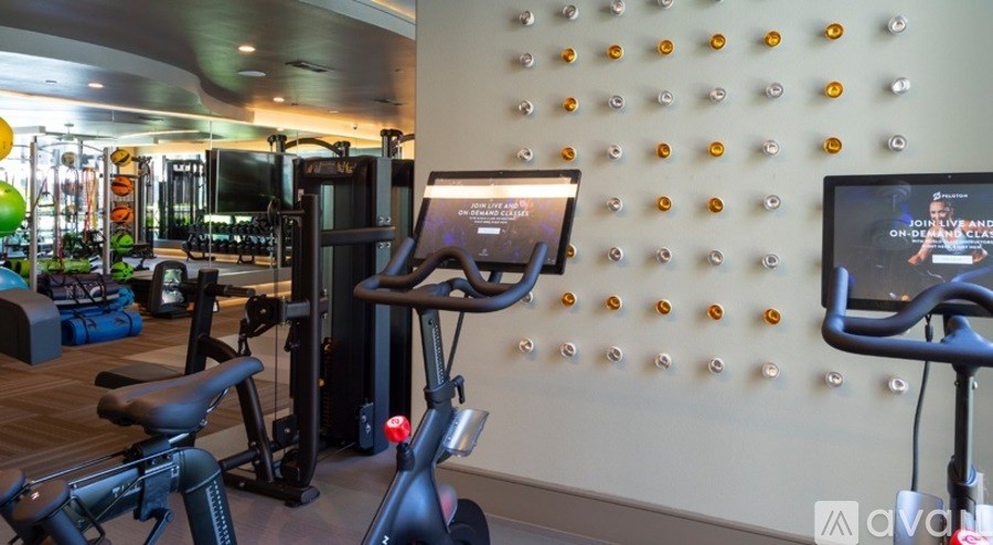 A gym with a variety of equipment including a stationary bike and a treadmill.