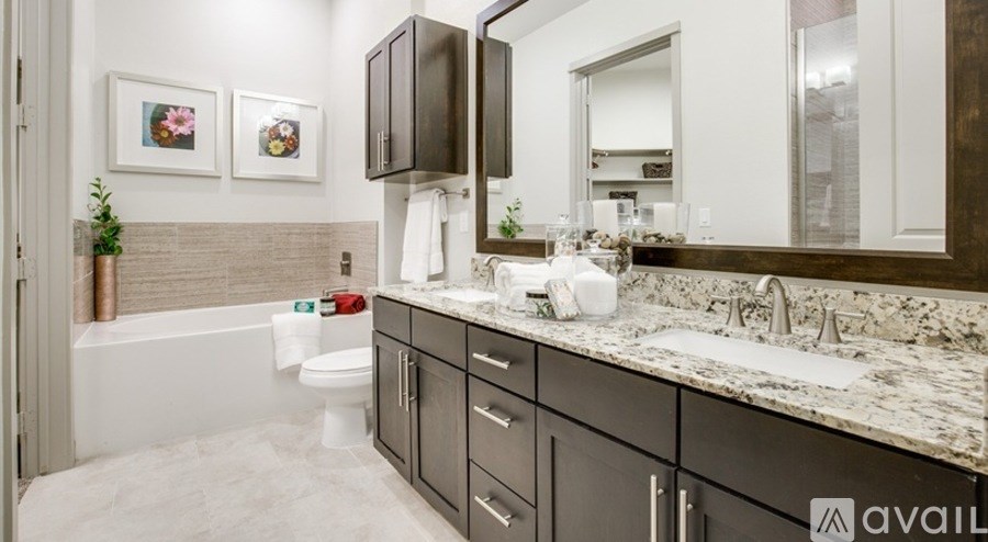 A bathroom with a marble countertop and a white toilet.
